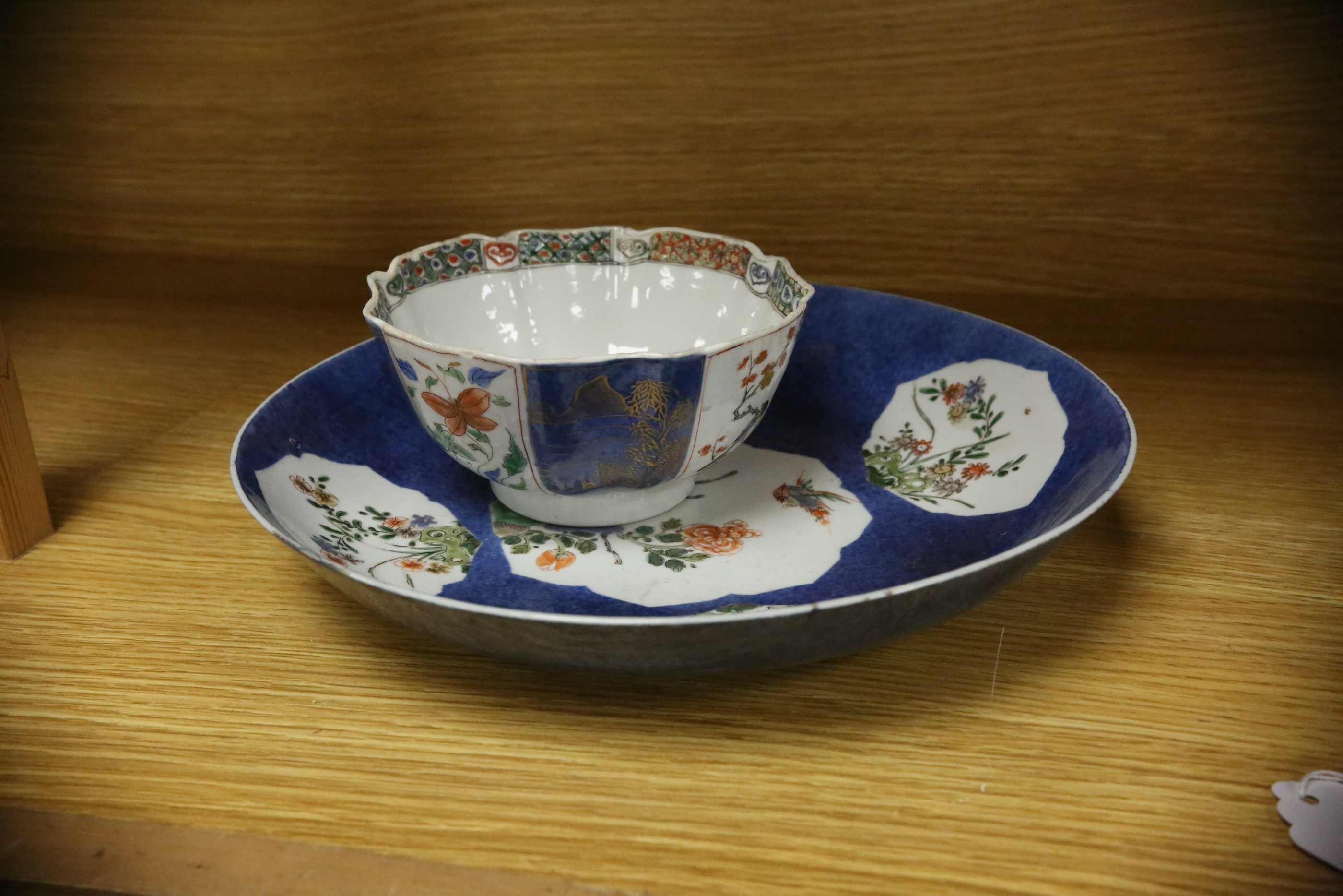 A Chinese famille verte powder blue ground bowl and a similar dish, both Kangxi period, 27.5cm diameter. Condition - dish poor, bowl fair